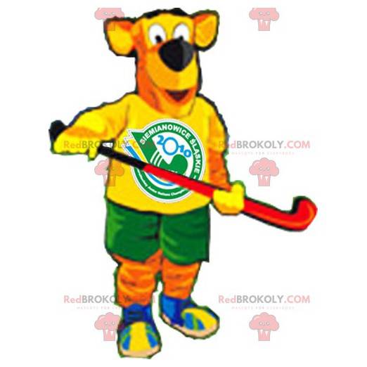 Mascotte de chien orange et jaune en tenue de hockey -