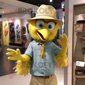 Yellow Harpy mascot costume character dressed with a Chambray Shirt and Hats