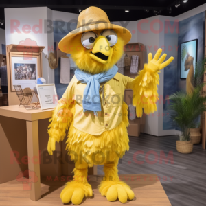 Yellow Harpy mascot costume character dressed with a Chambray Shirt and Hats