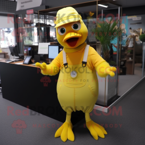 Yellow Pigeon mascot costume character dressed with a Dungarees and Gloves
