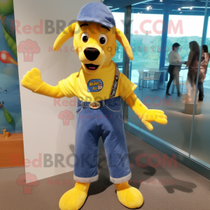 Yellow Dog mascot costume character dressed with a Chambray Shirt and Belts
