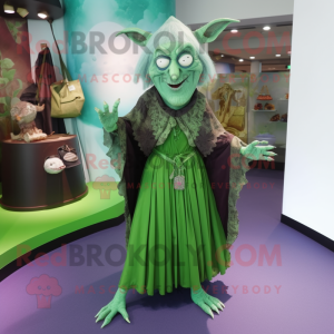 Green Witch mascot costume character dressed with a Wrap Dress and Handbags