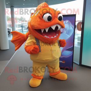 Orange Piranha mascot costume character dressed with a Oxford Shirt and Foot pads