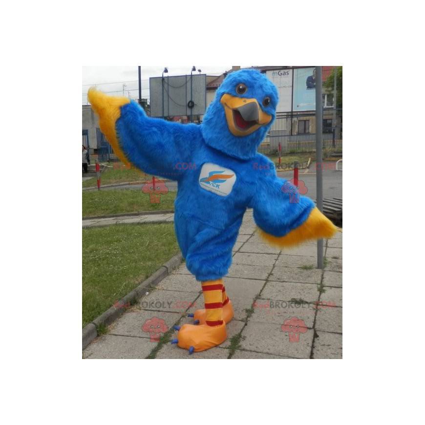 Mascota águila azul y amarilla. Mascota buitre colorido -