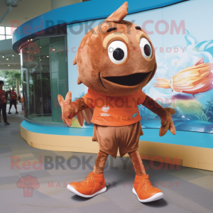Brown Goldfish mascot costume character dressed with a Running Shorts and Shoe laces