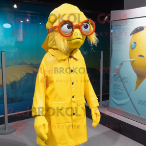 Yellow Betta Fish mascot costume character dressed with a Raincoat and Eyeglasses