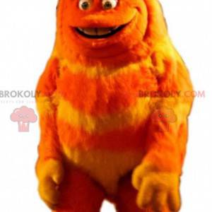 Mascotte de monstre poilu orange et jaune. Créature poilue -
