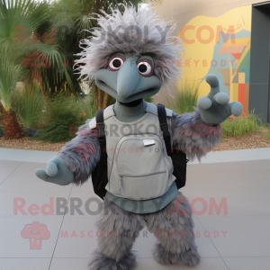 Gray Emu mascot costume character dressed with a Flare Jeans and Messenger bags