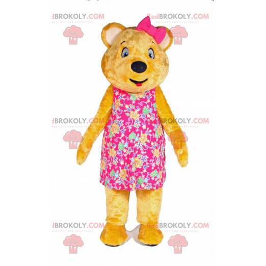 Yellow teddy bear mascot with a dress and a bow on the head -