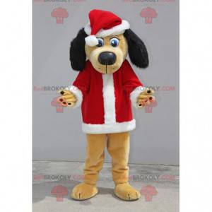Mascotte de chien beige et noir habillé en père Noël -