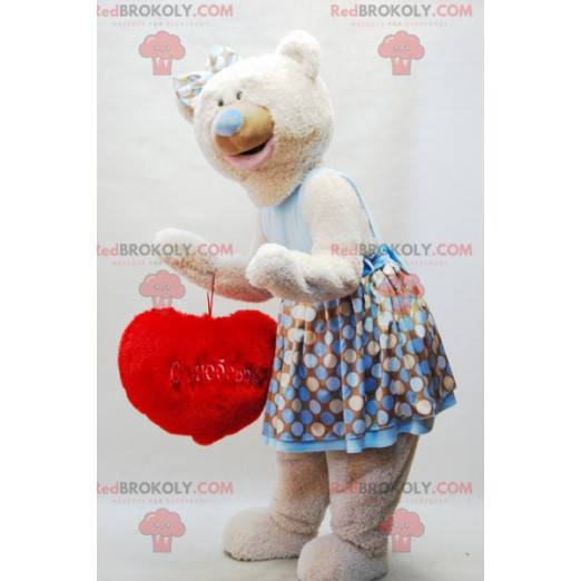 Beige teddy bear mascot with a dress and a red heart -
