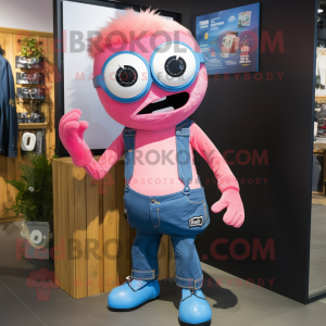 Pink Cyclops mascot costume character dressed with a Denim Shirt and Keychains