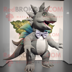 Gray Stegosaurus mascot costume character dressed with a Bermuda Shorts and Bow ties