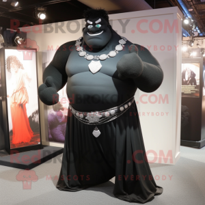 Black Strongman mascot costume character dressed with a Evening Gown and Shawl pins