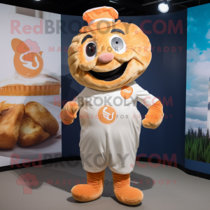 Peach Croissant mascot costume character dressed with a Dungarees and Lapel pins