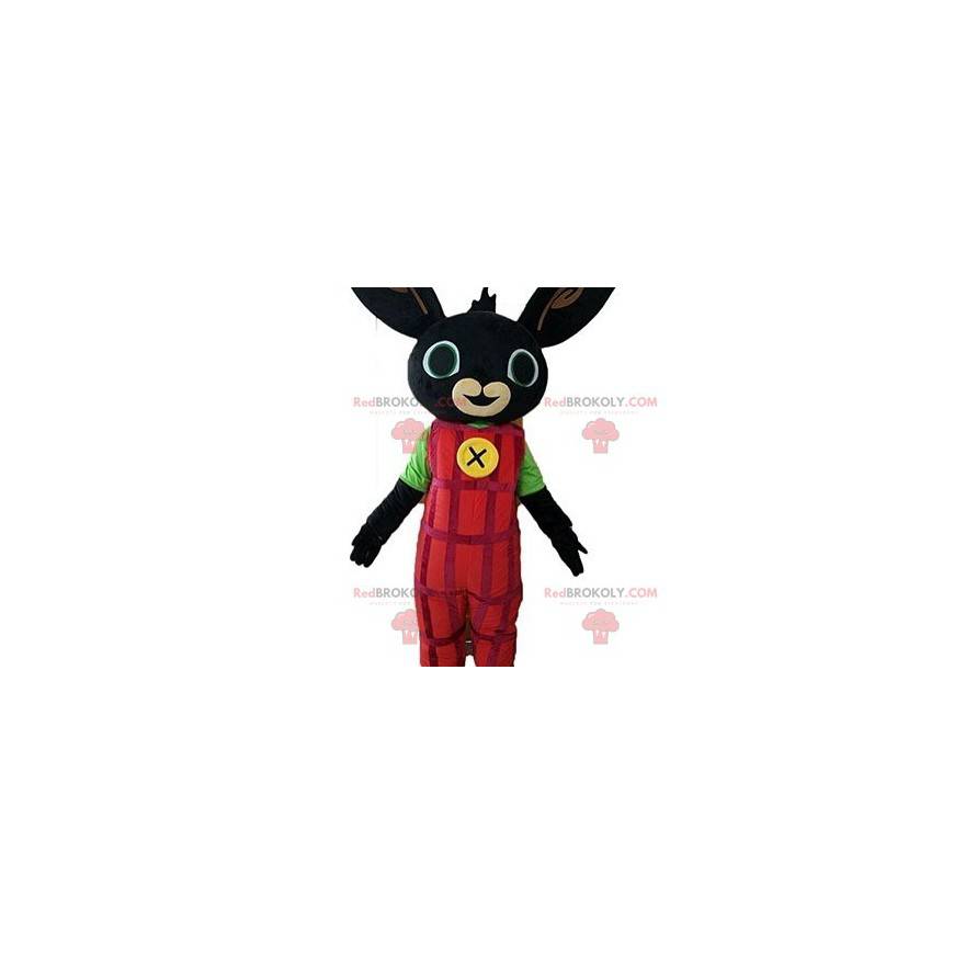Mascota del conejo negro vestida con un mono rojo -
