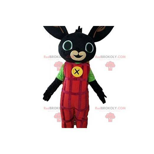 Mascote coelho preto vestido com macacão vermelho -