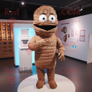 Brown Mummy mascot costume character dressed with a Poplin Shirt and Lapel pins