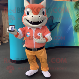 Peach Shark mascot costume character dressed with a Button-Up Shirt and Smartwatches