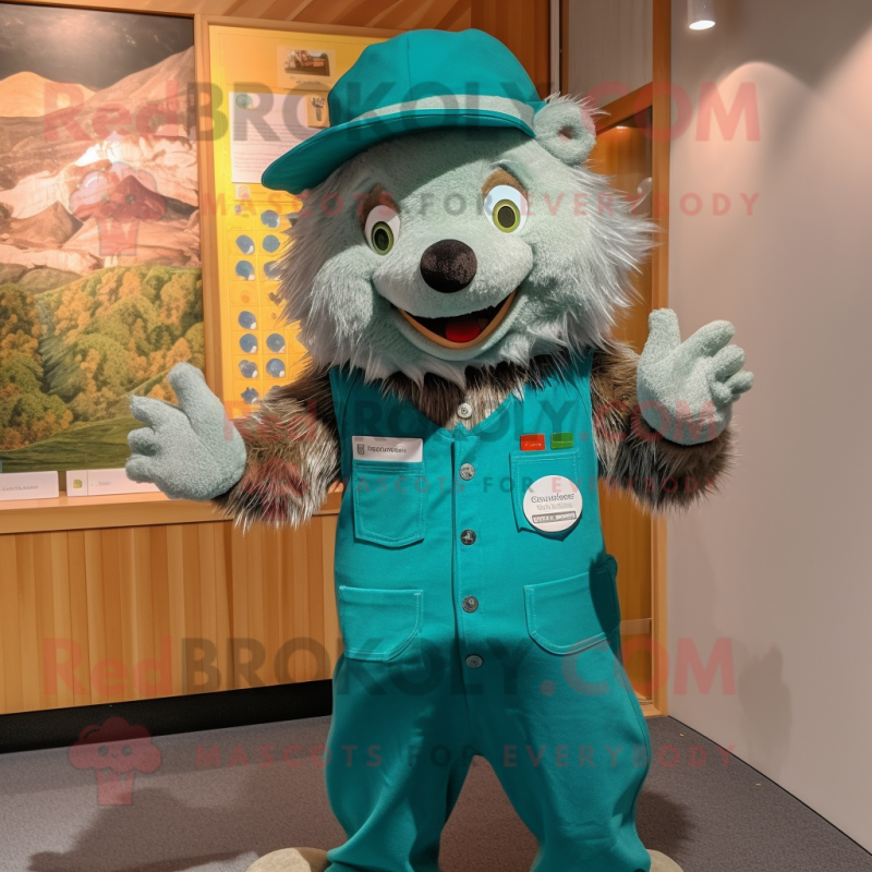 Teal Hedgehog mascot costume character dressed with a Dungarees and Hat pins Teal Hedgehog mascot costume character dressed with a Dungarees and Hat pins