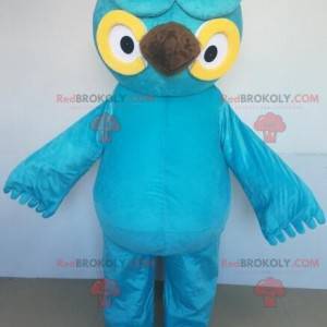 Giant blue and yellow owl mascot with big eyes - Redbrokoly.com