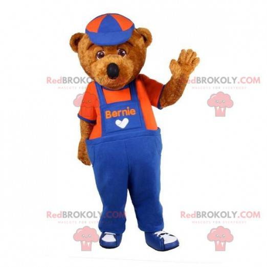 Mascote urso de pelúcia marrom vestido de macacão -