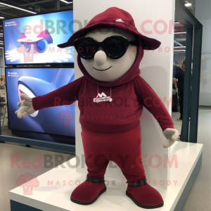 Maroon Trapeze Artist mascot costume character dressed with a Hoodie and Sunglasses