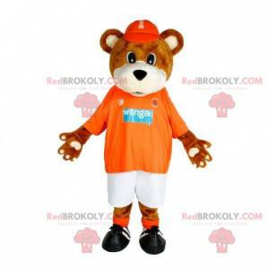Mascote urso marrom e branco em roupas esportivas -