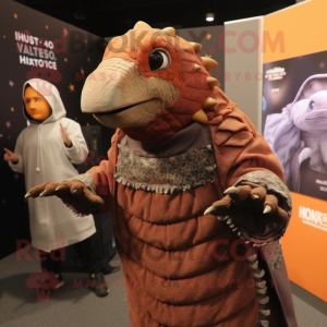 Rust Armadillo mascot costume character dressed with a Hoodie and Shawls