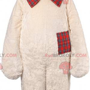 Mascota del oso de peluche beige con una pajarita a cuadros -