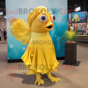 Yellow Betta Fish mascot costume character dressed with a Shift Dress and Shoe clips