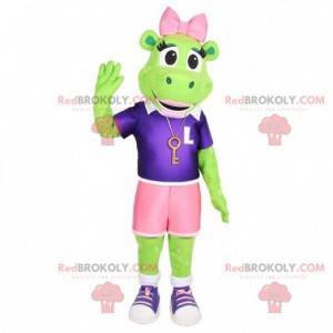 Mascota de la rana verde con pantalones cortos y un lazo rosa -