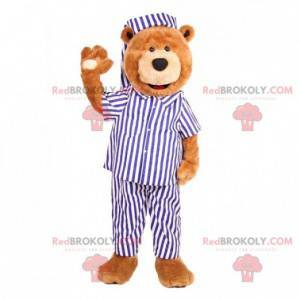 Teddybär Maskottchen in einem blau-weißen Pyjama gekleidet -