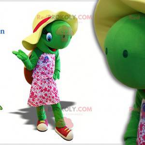 Mascota de la tortuga verde con un sombrero y un vestido rosa -