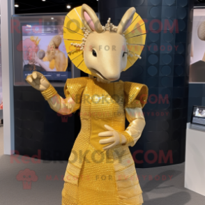 Gold Armadillo mascot costume character dressed with a Shift Dress and Hair clips