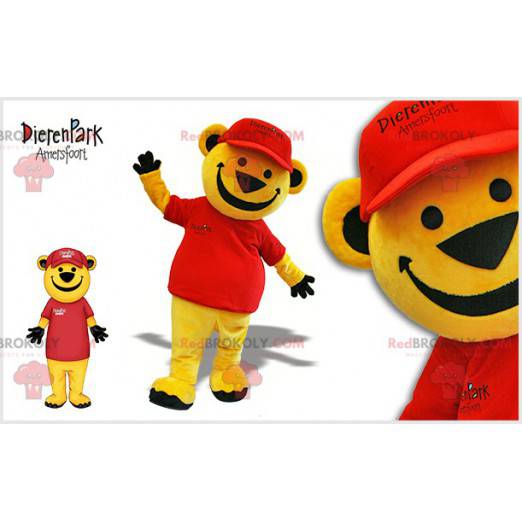 Mascota del oso de peluche amarillo vestida de rojo. Osito de