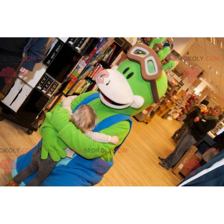 Mascotte de bonhomme vert avec une salopette bleue -