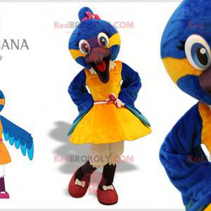 Blaues und gelbes Vogelmaskottchen mit einem Kleid -