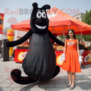 Black Currywurst mascot costume character dressed with a Maxi Skirt and Shoe laces