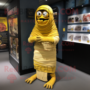 Yellow Mummy mascot costume character dressed with a Cover-up and Shoe clips