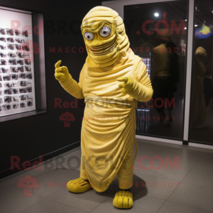 Yellow Mummy mascot costume character dressed with a Cover-up and Shoe clips