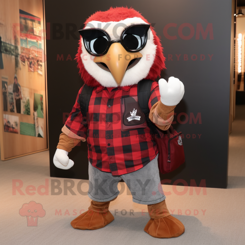 Red Hawk mascot costume character dressed with a Flannel Shirt and Backpacks