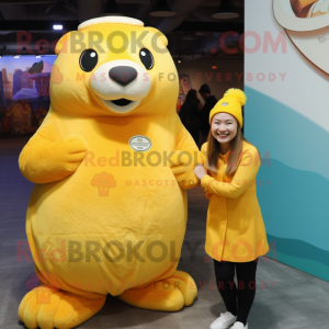 Yellow Sea Lion mascot costume character dressed with a Skirt and Mittens