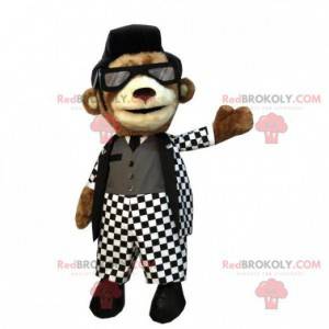 Brown teddy bear mascot with a white and black rock outfit -