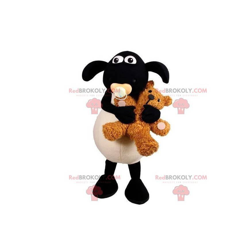 Mascota de cordero blanco y negro con un chupete en la boca -