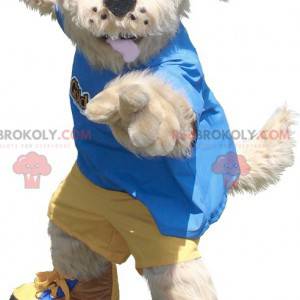 Beige hundemaskot i gul og blå tøj - Redbrokoly.com
