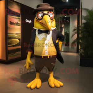 Gold Toucan mascot costume character dressed with a Oxford Shirt and Eyeglasses