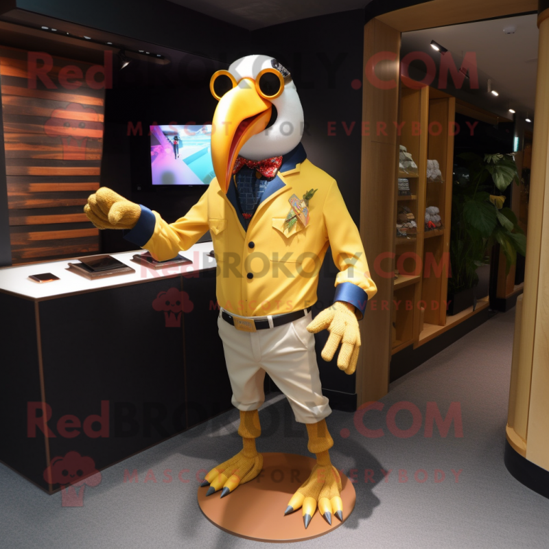 Gold Toucan mascot costume character dressed with a Oxford Shirt and Eyeglasses Gold Toucan mascot costume character dressed with a Oxford Shirt and Eyeglasses