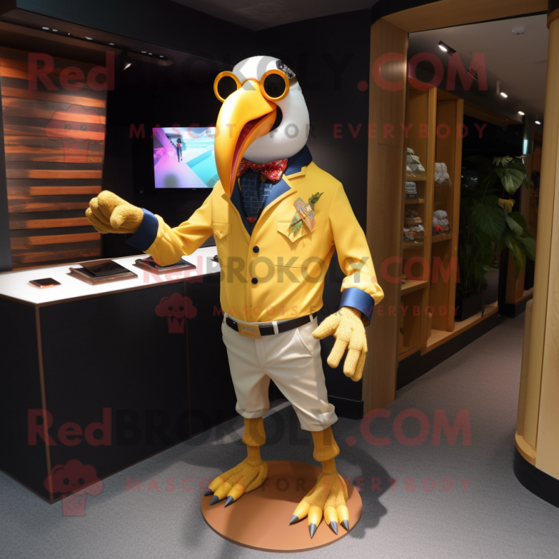 Gold Toucan mascot costume character dressed with a Oxford Shirt and Eyeglasses