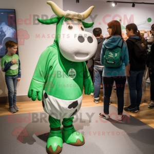 Green Guernsey Cow mascot costume character dressed with a Graphic Tee and Watches